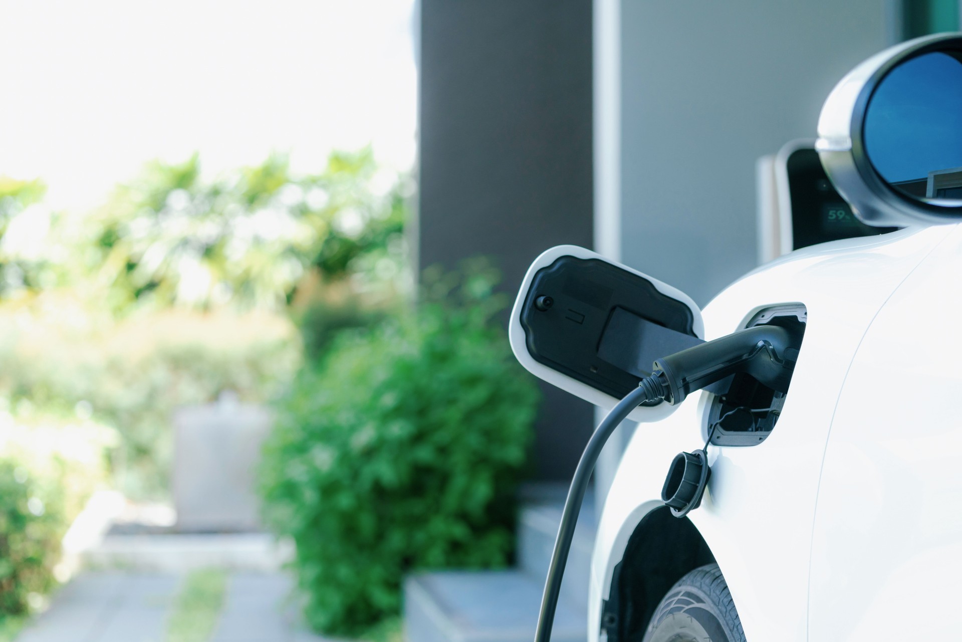 EV car plugged-in with cable from progressive home charging station.
